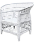Angled view of a white Malawi Cane Chair – Highlighting the curved shape and detailed artisan weaving from the front-right perspective.