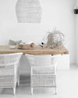Minimalist dining setting with white Malawi Chairs and natural wood table – Clean, bright interior styled with neutral tones and organic decor.