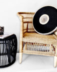 Natural Malawi Chair with black African shield and matching black side table – A bold, contemporary setup fusing traditional design and modern styling.